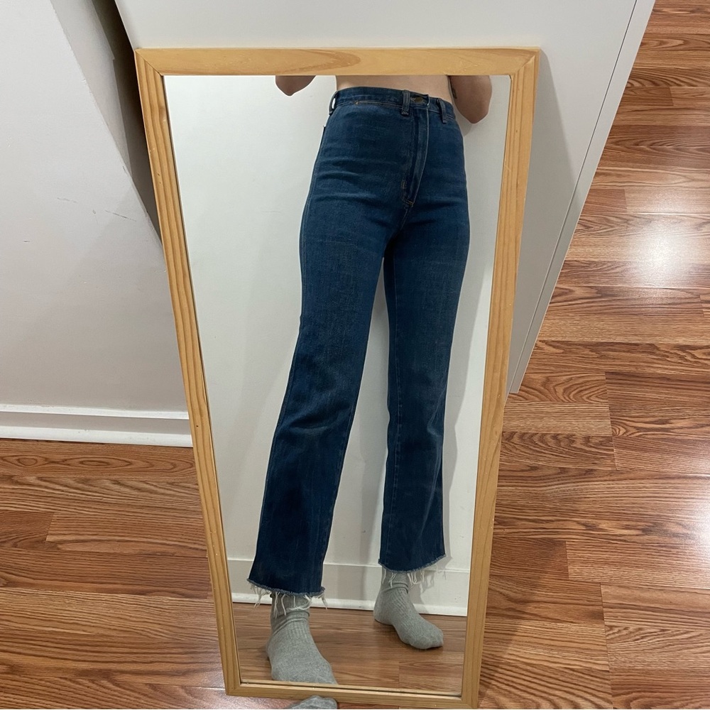 Vintage high waisted wrangler jeans with raw cuff and slight flare.